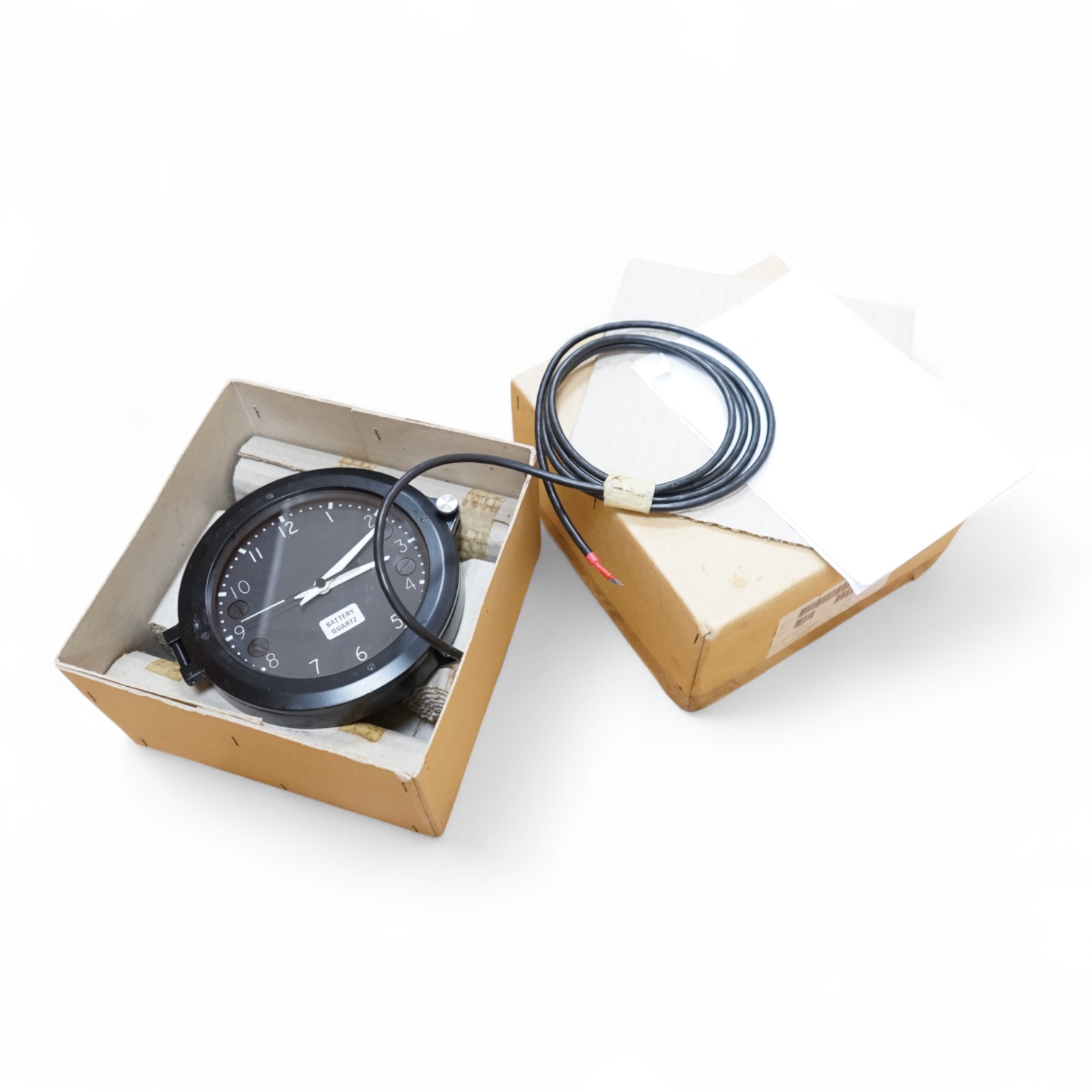 A modern British MOD Royal Navy issue quartz powered electric timepiece by S.I.R.S. Navigation Ltd. in its original card issue box